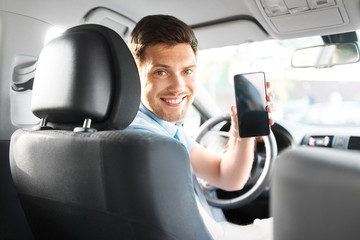 transport, driving and technology concept - man or car driver showing smartphone