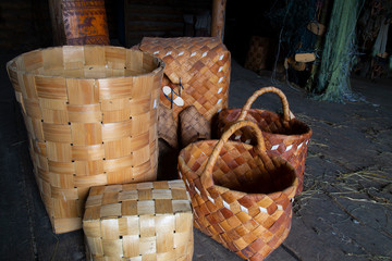 Basket. Products made of birch bark on the background of old pine boards.