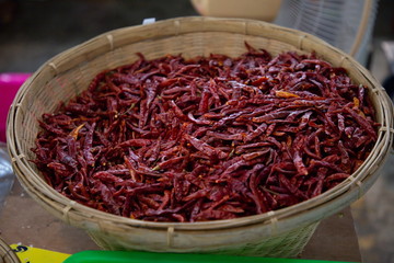 heap of dry chili vegetable in market .