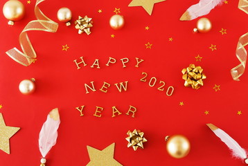 christmas or new year decorations background in gold colors on red color background with empty copy space for text. holiday and celebration concept for postcard or invitation. top view 