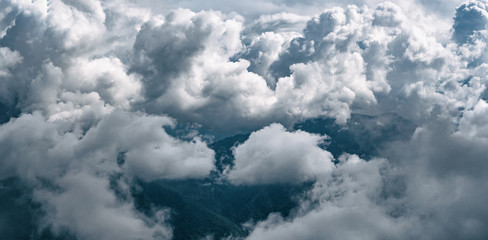 Panoramic view of cumulus clouds at mountains background at rainy day