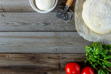 Ingredients for pizza. Dough, tomatoes, mozzarella, basil. Italian cuisine.