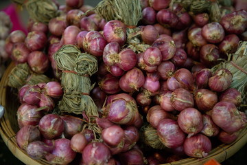 heap of onions vegetable in market .