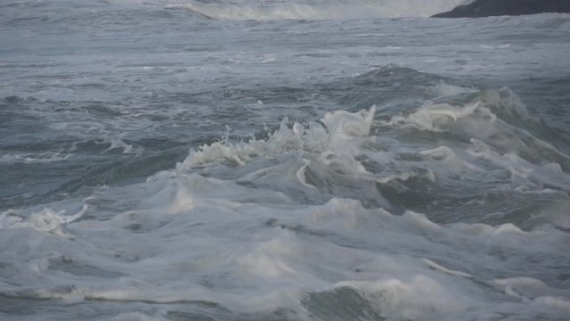 Waves rolling on the beach is a stormy day, winter mediterranean sea. Focene, Lazio, Italy. Slow motion