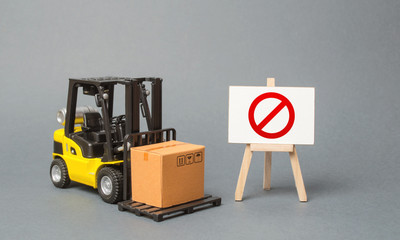 Forklift truck carries a cardboard box near a stand with a red symbol NO. No delivery. Restriction...