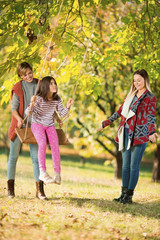 Obraz premium Beautiful mother and aunt with a child outdoors