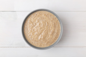 Mushroom cream soup on a wooden background