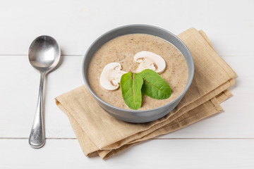 Mushroom cream soup on a wooden background