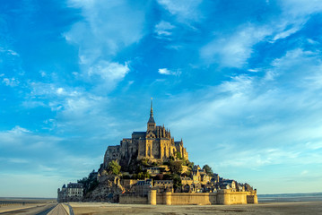 Fototapeta na wymiar Dawn in Mont Saint Michel and its abbey with the sea at low tide