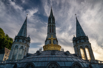 Front view of the sanctuary of Our Lady of Lourdes (France) during sunset.