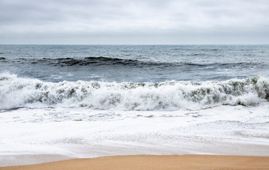 Fototapeta na wymiar Nazare, Portugal - Crashing waves at the Praia do Norte or North beach at the Praia do Norte or North beach