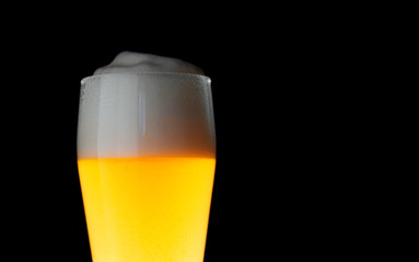 A glass of wheat beer on a dark background close-up with copyspace