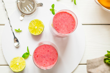 Two Glasses of Smoothie with Berries, Grapefruit, Lemon, Lime and Mint on White Wooden Background, Detox Time, Top View