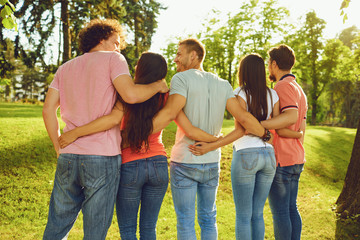 Groups of friends are embraced in the park in nature.