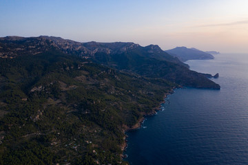 Fototapeta premium Coastline Sunset view, the mountains are silhouetted against the horizon. 