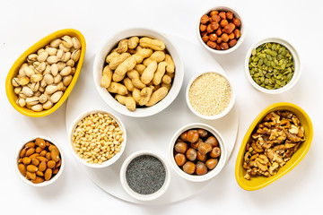 Various Nuts and Seeds on White Background in the Bowls - Image