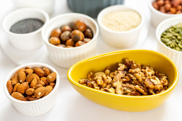 Various Nuts and Seeds on White Background in the Bowls - Image