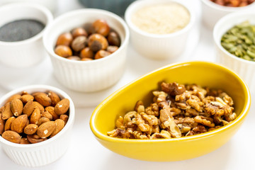 Various Nuts and Seeds on White Background in the Bowls - Image