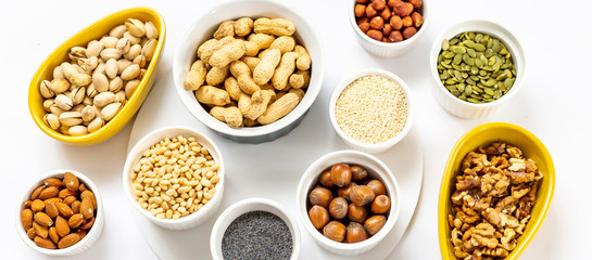 Panoramic View of Different Kind of Nuts and Seeds on White Background in the Bowls - Image