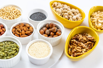 Various of Nuts and Seeds on White Background in the Bowls - Image