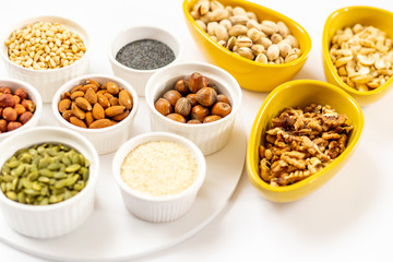 Various of Nuts and Seeds on White Background in the Bowls - Image