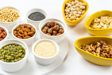 Various of Nuts and Seeds on White Background in the Bowls - Image