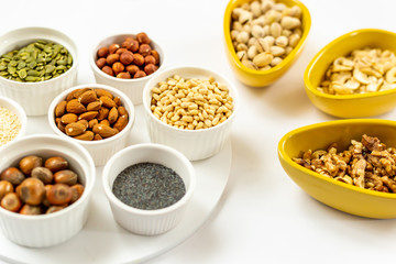 Various of Nuts and Seeds on White Background in the Bowls - Image