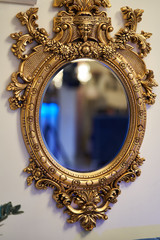 Old carved round mirror with gilding