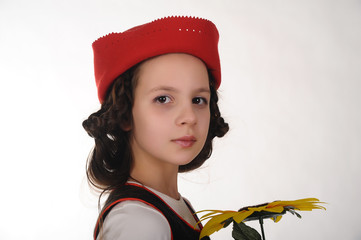 Girl in a red cap with a sunflower. Course, fashion.