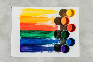 Action painting. Abstract Hand-painted rainbow art background. Multicolored paint strokes and brush