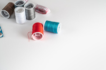 Sewing thread bobbins on the white background. Closeup.