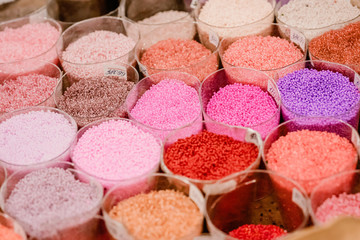 Colorful glass beads pattern. Beading. Variety of color beads in handmade shop