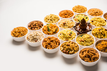 Rangoli of Farsan/snacks in bowls for Diwali with diya