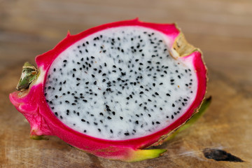 Dragon fruit on old wooden table background.
