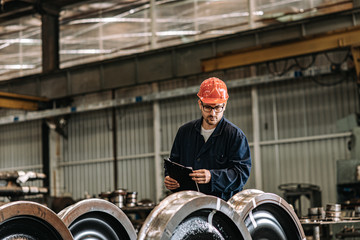 Portrait of a quality control inspector at train factory.