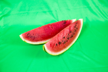 Plakat Close-up of a piece of refreshing watermelon on a light green background. Raw organic fruit. Useful product