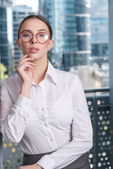 Fototapeta premium Young businesswoman (real estate agent) presenting detached modern office