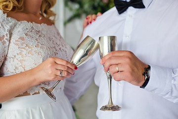 bride and groom holding glass of champagne