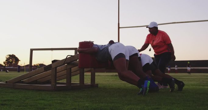 Young adult female rugby players training