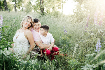 a family sits among greenery lawn