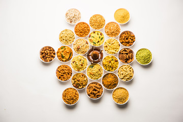 Rangoli of Farsan/snacks in bowls for Diwali with diya