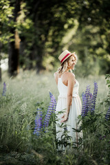 woman stands half turned a back among greenery lawn