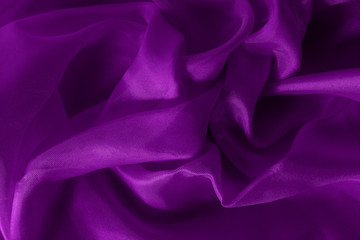 Dark purple fabric cloth texture for background and design art work, beautiful crumpled pattern of silk or linen.