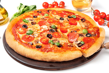 Pepperoni pizza with salami slices, black olives, mushrooms, fresh basil leaves and a lot of cheese