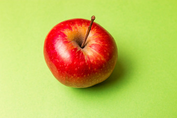 A big red apple on a green background