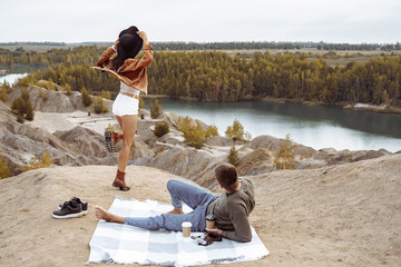 Happy couple enjoying a picnic together. Travel, lifestyle and people concept.