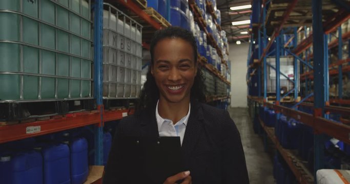 Portrait of young female manager in a warehouse