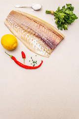 Raw cod loin fillet with lemon, sea salt, chili and cayenne pepper, parsley