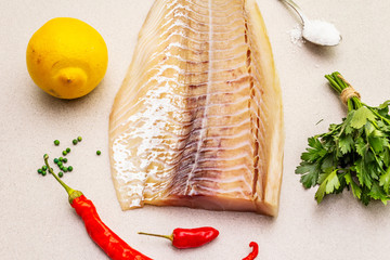 Raw cod loin fillet with lemon, sea salt, chili and cayenne pepper, parsley
