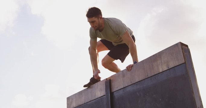 Young man training at an outdoor gym bootcamp